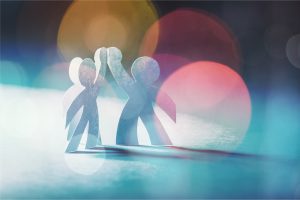 Circle of paper people on abstract background